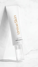 A white tube of Ekseption Spotless UltraSerum on plain background.